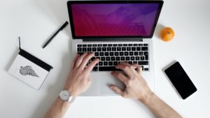 typing on his laptop