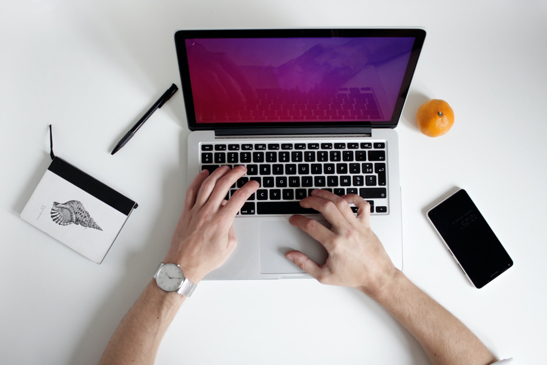 typing on his laptop